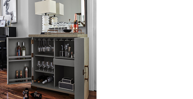 When Jenny comes home, the first thing she often does is place her bag down and take off her stylish shoes. So, they created an elegant space for her to do just that by using the Vienna Bar Cabinet. The top acts as a catch-all for the day’s wares while inside serves as storage for entertaining essentials like wine glasses and barware. It all speaks to the Parisian vibe as well—the mirror is one Jenny found in a Parisian market, and the bar cabinet is covered in faux shagreen, a material that first gained popularity in 1930s Paris. When Jenny comes home, the first thing she often does is place her bag down and take off her stylish shoes. So, they created an elegant space for her to do just that by using the Vienna Bar Cabinet. The top acts as a catch-all for the day’s wares while inside serves as storage for entertaining essentials like wine glasses and barware. It all speaks to the Parisian vibe as well—the mirror is one Jenny found in a Parisian market, and the bar cabinet is covered in faux shagreen, a material that first gained popularity in 1930s Paris.