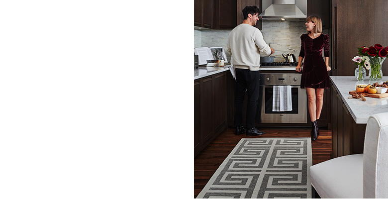 The kitchen is open to the rest of the home, so every detail had to be both beautiful and functional. The Perennials Greek Key rug is designed for indoor and outdoor use, perfect for the kitchen of dog-owners since it is durable and can be easily wiped clean. “The overscale Greek key pattern in the kitchen rug makes a narrow space look bigger,” notes Lainey. The overall effect is a space that’s luxurious yet livable, perfect for a stylish couple like Jenny and Freddie. The kitchen is open to the rest of the home, so every detail had to be both beautiful and functional. The Perennials Greek Key rug is designed for indoor and outdoor use, perfect for the kitchen of dog-owners since it is durable and can be easily wiped clean. “The overscale Greek key pattern in the kitchen rug makes a narrow space look bigger,” notes Lainey. The overall effect is a space that’s luxurious yet livable, perfect for a stylish couple like Jenny and Freddie.