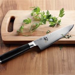 This is an image of a knife for food preparation on a cutting board